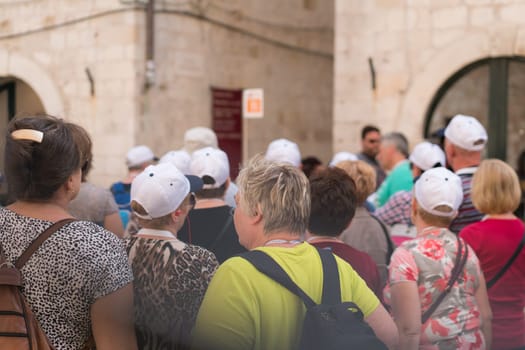 Dubrovnik, Croatia - April 2018 : Organized tour of tourists walking on the main street in Dubrovnik Old Town