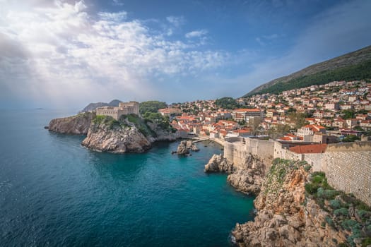 Dubrovnik, Croatia - April 2018 : Rocky coast alongside Dubrovnik Old Town massive defence walls of fortress Bokar