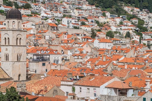 Dubrovnik, Croatia - April 2018 : Church bell tower and rooftops of old hillside houses in Dubrovnik, viewed from the Old Town fortified walls