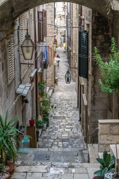 Dubrovnik, Croatia - April 2018 : Steps on the steep narrow street passage between residential buildings in the Dubrovnik Old Town