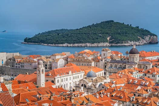 Dubrovnik, Croatia - April 2018 : Rooftops of old houses in Dubrovnik, viewed from the Old Town fortified walls with Lokrum Island in the background
