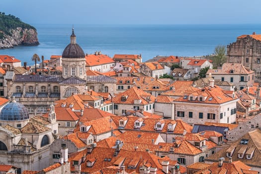 Dubrovnik, Croatia - April 2018 : Rooftops of old houses in Dubrovnik, viewed from the Old Town fortified walls with Lokrum Island in the background