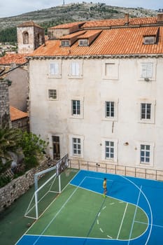 Dubrovnik, Croatia - April 2018 : Basketball court and football pitch in front of the old houses and buildings in Dubrovnik, viewed from the Old Town fortified walls