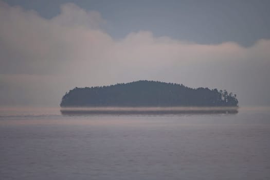 Island Appearing out of the Morning Fog on Saganaga Lake in Quetico Provincial Park in Ontario