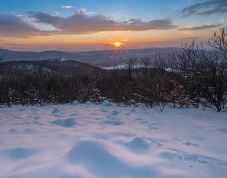 Sunset and Hills covered by snow