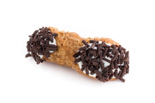 Sweet cannolo stuffed with ricotta cheese cream and chocolate flakes. Traditional Sicilian dessert.