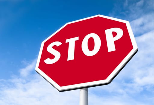 Forefront of a stop sign with a clear blue sky