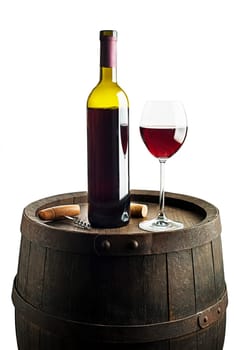 Glass and bottle of red wine on wooden barrel background