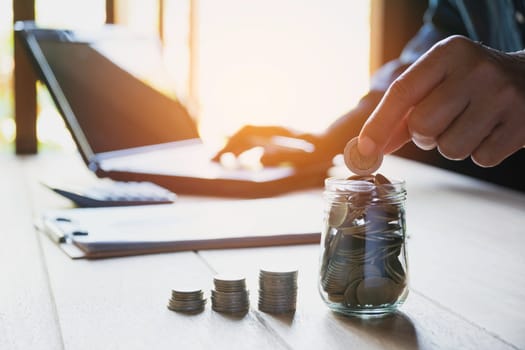 Hand drop a coin with money coin stack growing for business. financial and accounting concept.