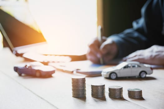 Car insurance and car service. Businesswoman and toy car, business and financial concept.