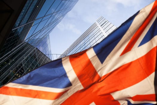 brexit concept - UK economy after Brexit deal - double exposure of flag and Canary Wharf business center skyscrapers
