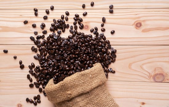 Coffee beans spilled out from burlap sack