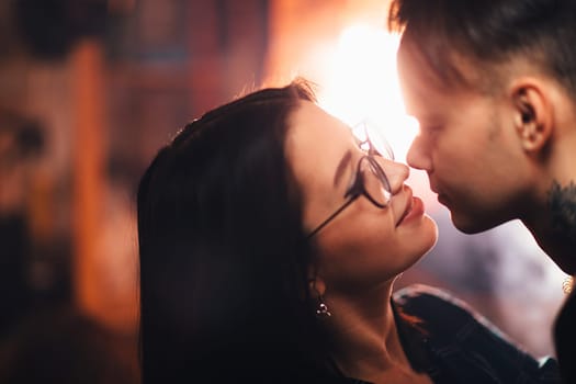 Couple in fashionable clothes on a shiny background.