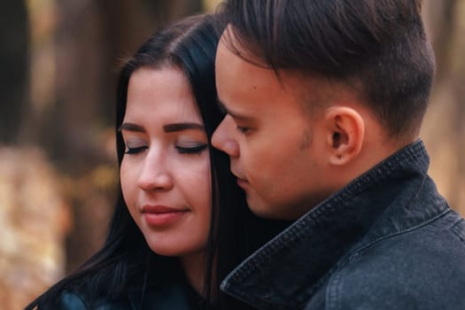 portrait of a young woman and a man walking in the autumn forest.