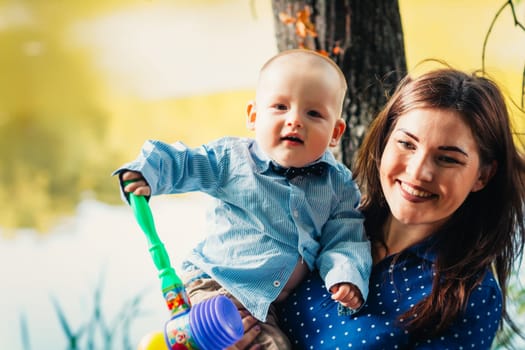 happy mother and toddler son on nature background.