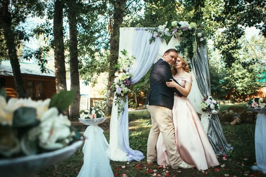 bride and groom on wedding ceremony on background nature.