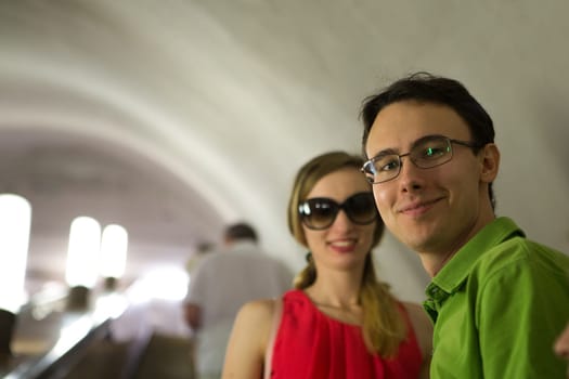 girl and guy on the background of the alley of garlands.