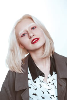 portrait of an albino girl in a raincoat in the studio.
