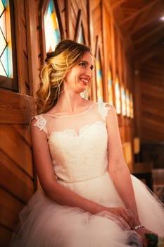 Portrait young beauty bride near the window.