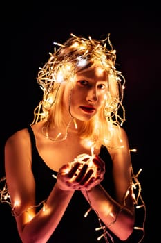 portrait of a girl with a garland on black background.