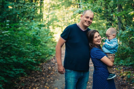 happy family with son on background forest