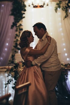 bride and groom first dancing on background a restaurant.