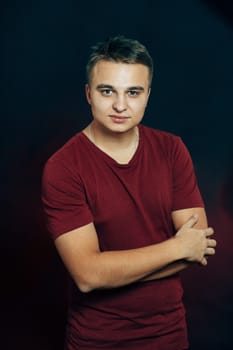 portrait of a young man on a dark background.