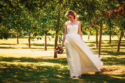 happy young bride on autumn forest background.