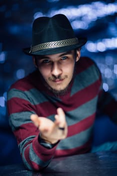 portrait of a guy in a hat on a blurred background.