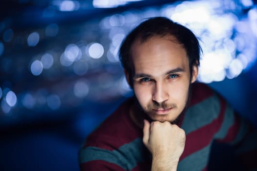 portrait of a guy in a hat on a blurred background.