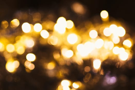 gold and silver bokeh on a dark background.