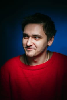 emotional young man photo in studio on blue background