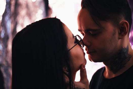guy and the girl kiss closeup on a light background