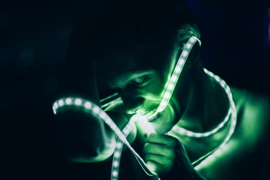 Portrait man Strip Light LED tape on dark color background.