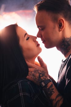 guy and the girl kiss closeup on a light background