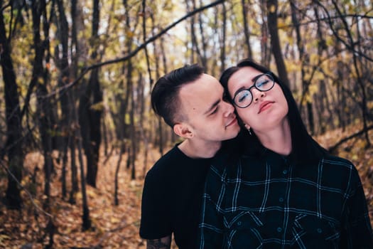 man and woman in the autumn forest