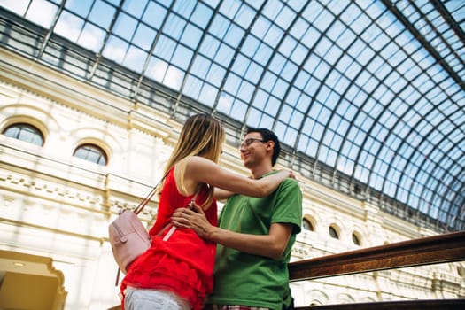 girl and guy stand on the background of the bridge