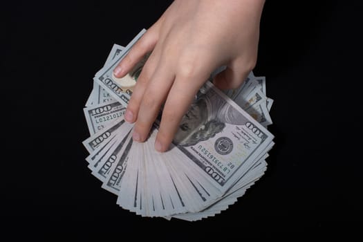 Hand holding American dollar  banknotes isolated on white background