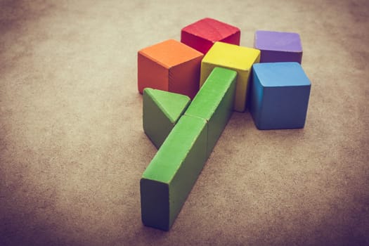 Colorful building  blocks form a flower on a brown background