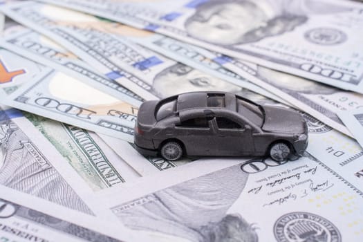 Model car placed US dollar banknotes spread on ground