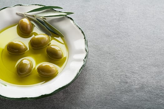 Extra virgin healthy Olive oil with fresh olives close up