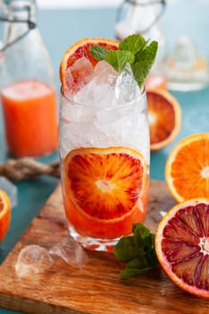 Cold cocktail with fresh bloodoranges and mint leaves