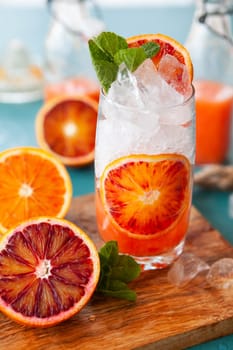 Cold cocktail with fresh bloodoranges and mint leaves