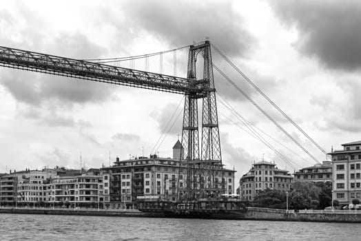 the suspension bridge of bizkaia (puente de vizcaya) between getxo and portugalete over the ria de bilbao, black and white