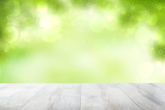 Empty table top summer background. Empty rustic wooden bright table top in front of beautiful abstract green summer or spring background. Template for product display montage. Space.
