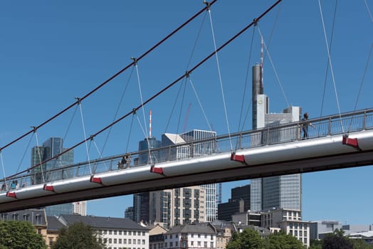 the holbeinsteg footbridge in front of the skyline in frankfurt am main, germany