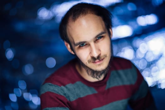 portrait of a guy in a hat on a blurred background.