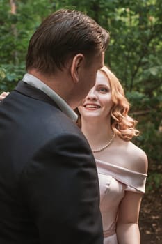 bride and groom dancing in the forest background and sunlight.