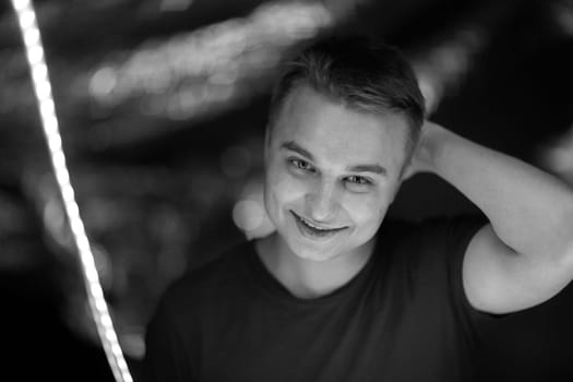 black white photo portrait of a young man on a blurred background.