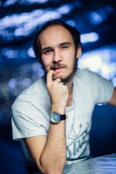 portrait of a guy in a hat on a blurred background.